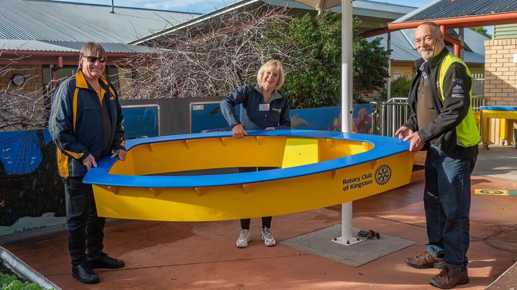 Rotary Members helping install a play boat at a local childcare centre.